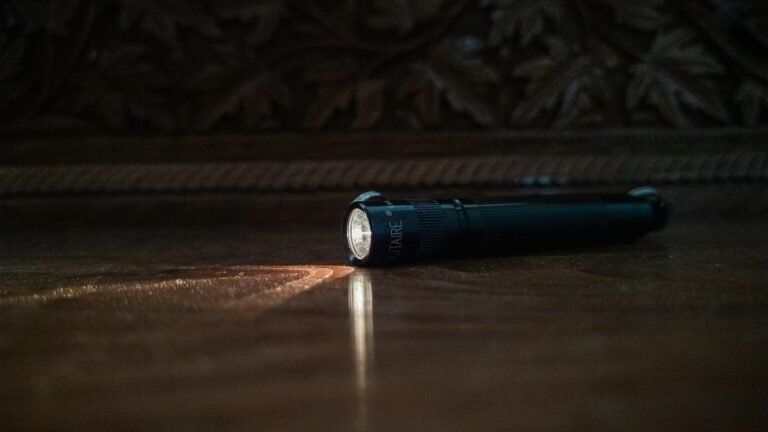 A flashlight on the floor of a dark room
