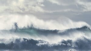 Ocean waves under a cloudy sky