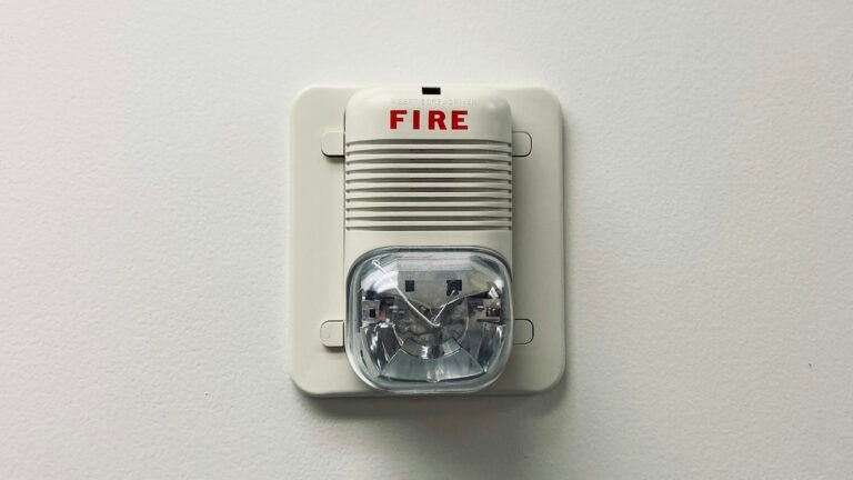 White smoke detector mounted on a wall